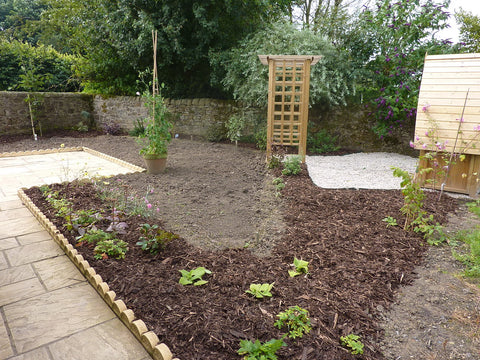 After you prepare a garden bed, place mulch on top to get rid of extra weeds.