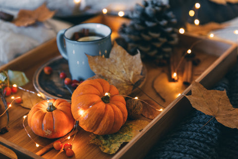 pumpkins and string lights with black blanket