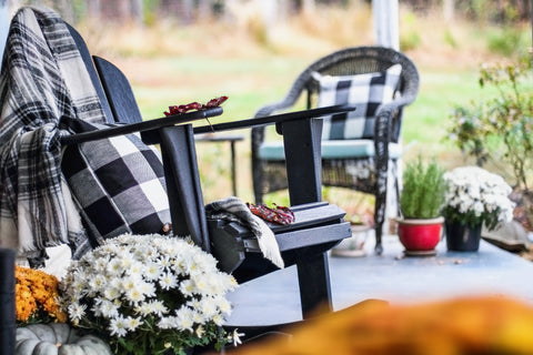 Adirondack chair on the patio decorated for fall