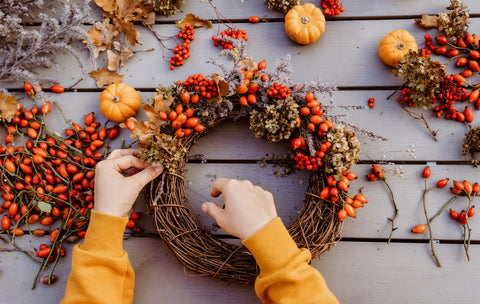 person creating a fall wreath