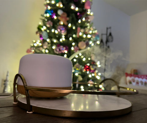 Diffuser on coffee table in front of Christmas tree