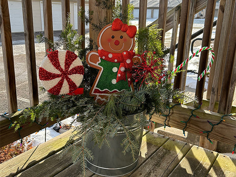 porch pot with gingerbread girl, candy cane, and peppermint stick