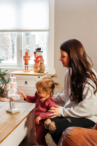 Mother and daughter playing with a nutcracker