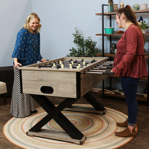 2 opponents playing a friendly game of foosball