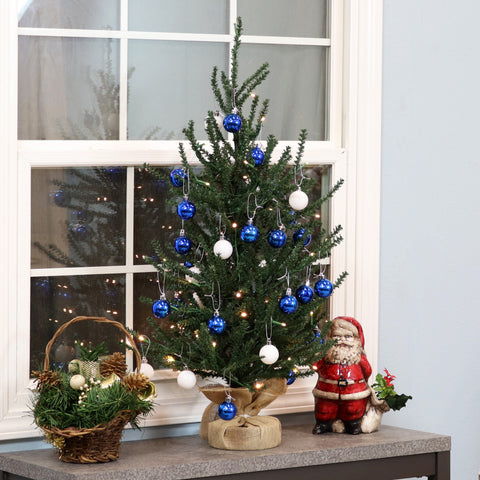 tabletop Christmas tree decorated with blue and white ornaments
