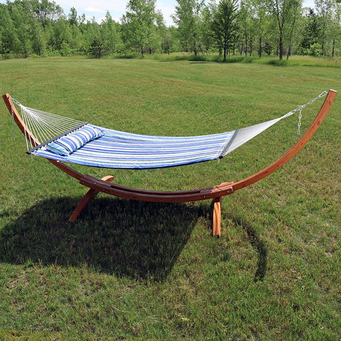 Hammock with a wooden stand in the yard.