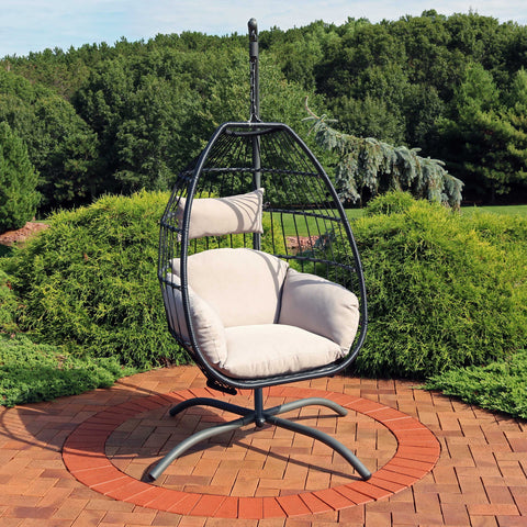 Egg chair hanging from the stand on a sunny patio