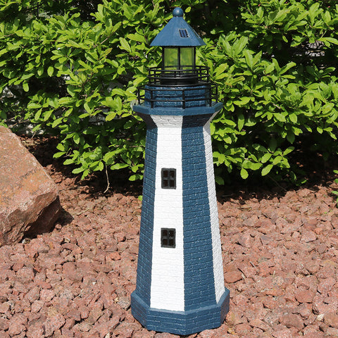 Lighthouse statue in front yard landscaping