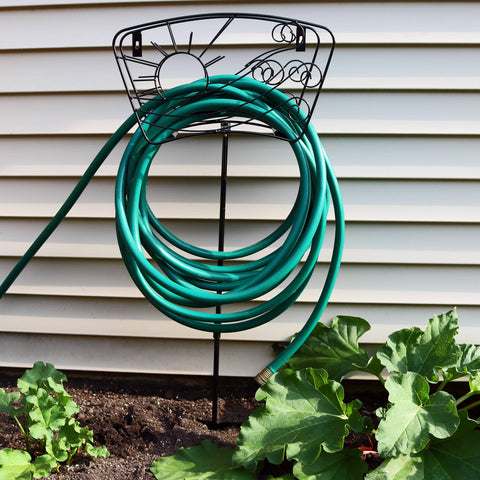 Hose stand with a green garden hose