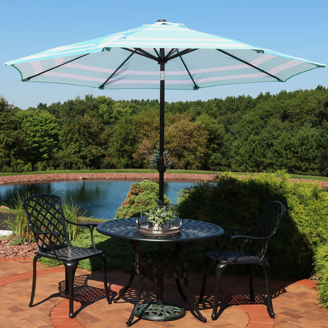 Beautiful striped market umbrella providing shade for a patio table.