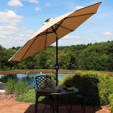 Umbrella with canopy tilted to shade a chair on the patio