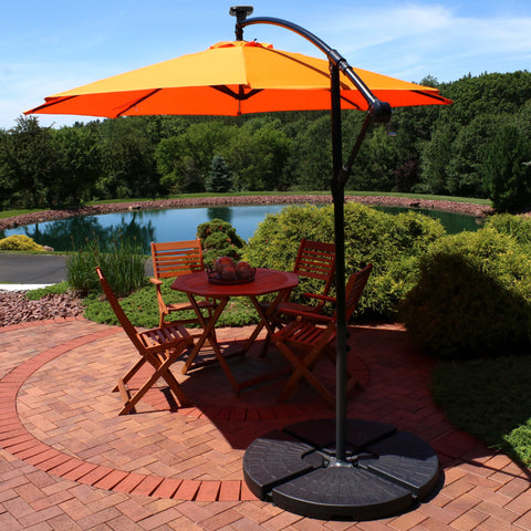 orange patio umbrella shading a patio furniture set