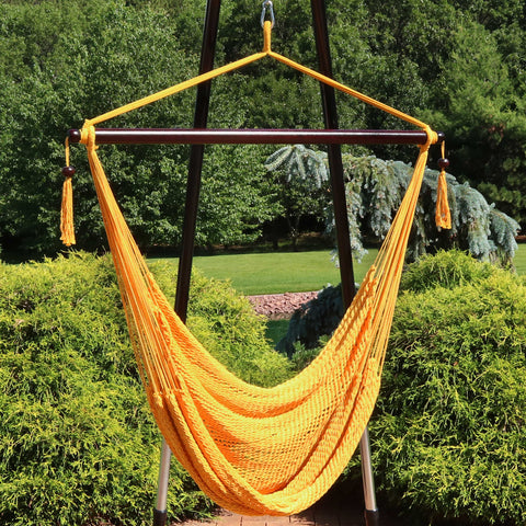 Hammock hanging chair with stand on display outside.