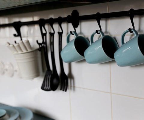 Mugs hanging from rack in kitchen