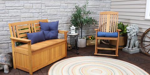 storage bench with outdoor cushions and pillows on a deck