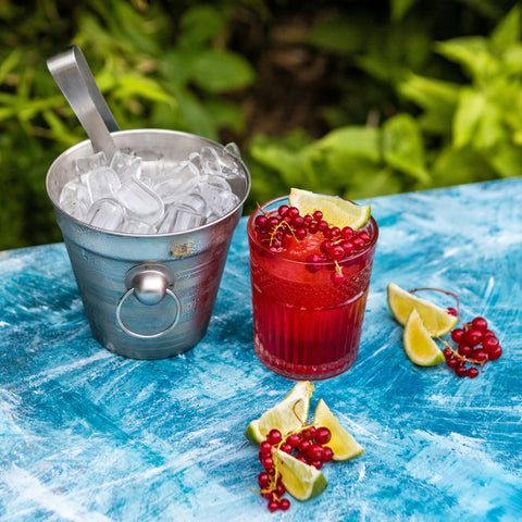 Bucket of ice and drink with fruit garnishes
