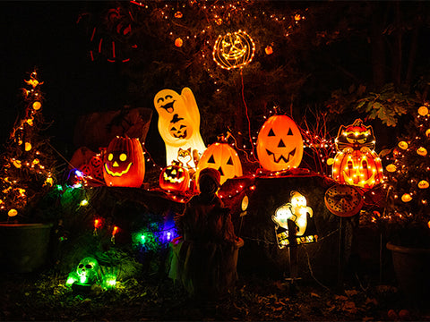 pumpkins and ghosts lit up in yard