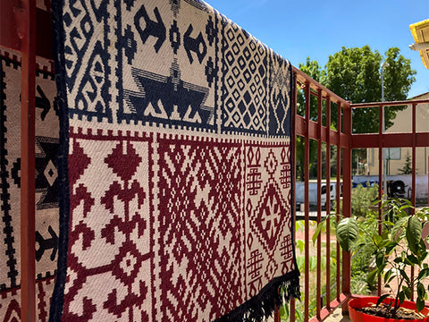 outdoor rug draped over railing for privacy