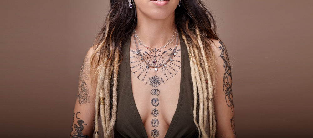 Chakra Gemstone Jewellery in gold and silver being worn by spiritual tattoo goddess