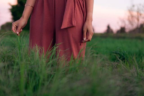 what is green fashion - a close up picture of a woman dressed in a pink jumpsuit