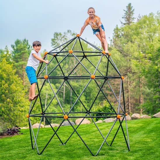 Two kids on a geometric climbing dome.