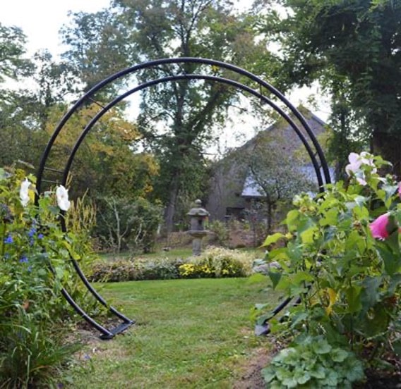 A garden arch made with an old trampoline frame.