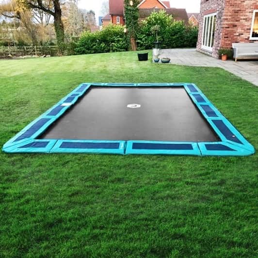 Inground trampoline in a backyard.