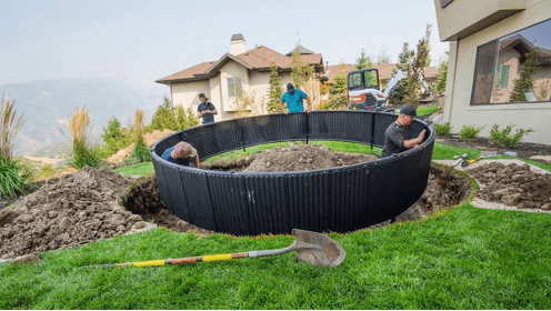 Workers installing an inground trampoline.