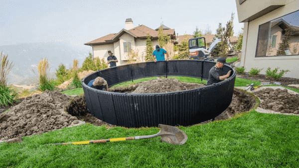 Workers installing an inground trampoline.