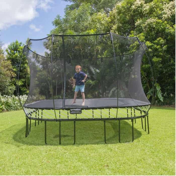 A little boy jumping on a Springfree Square Trampoline.