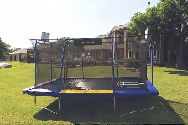 A JumpKing Rectangle Trampoline with two basketball hoops.