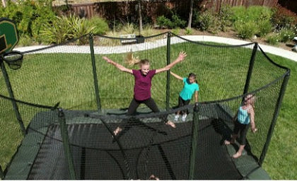 Multiple kids bouncing on a JumpSport Rectangle Trampoline.