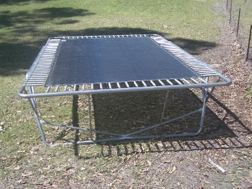 An old trampoline without a net or padding.