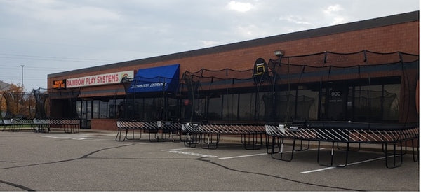 Five Springfree Trampolines displayed at a storefront.