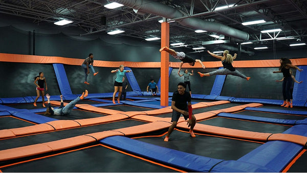 Multiple people jumping at SkyZone Trampoline Park.