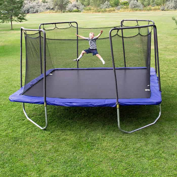 A little kid jumping on a blue Skywalker Square Trampoline.