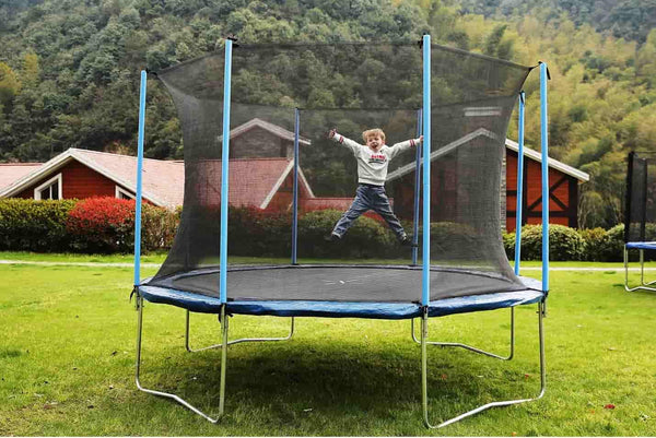 A little boy jumping on a spring trampoline.