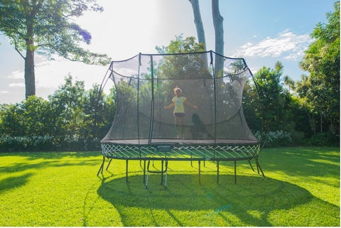 A girl jumping on an Oval Springfree Trampoline.