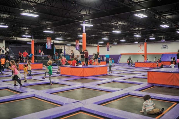 Kids playing at a trampoline park.