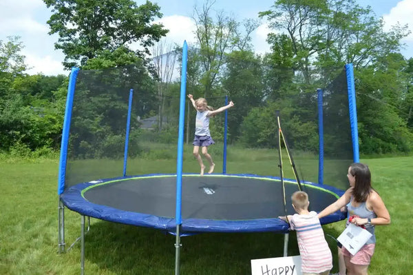 A little girl jumping on a Zupapa Trampoline while her family watches from the outside.