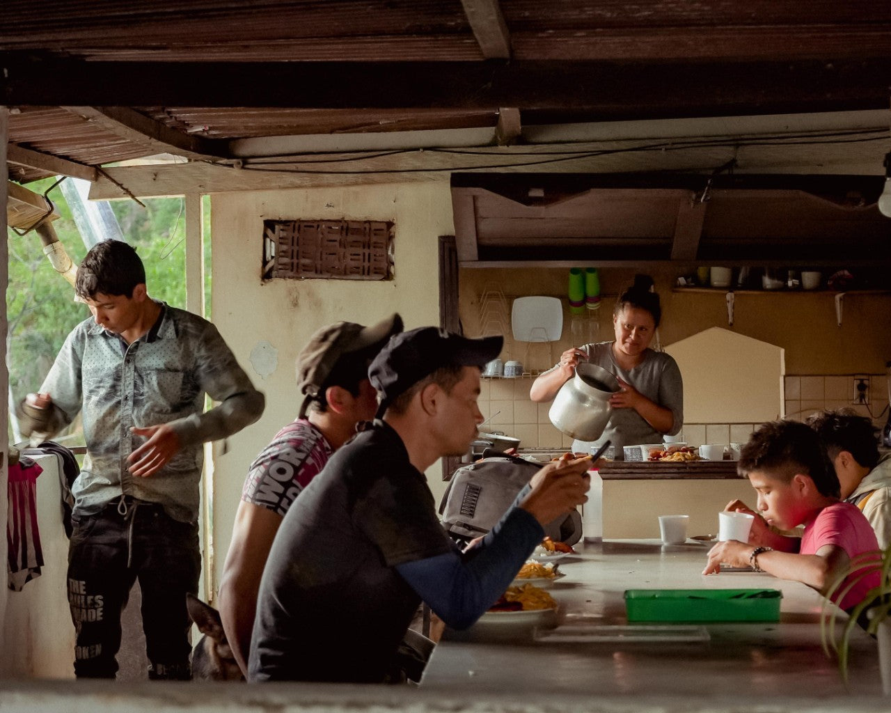 Colombian farming family enjoying coffee on smallholder farm