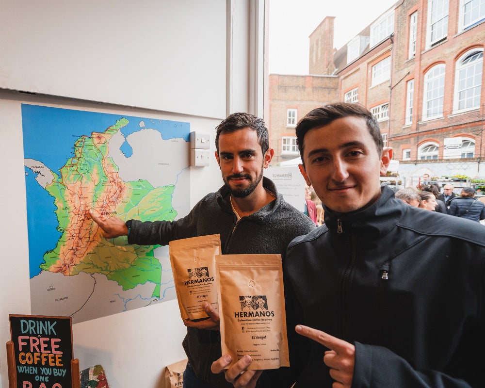 Elias and Shady Bayter holding their coffee in Hermanos packaging on Columbia Road