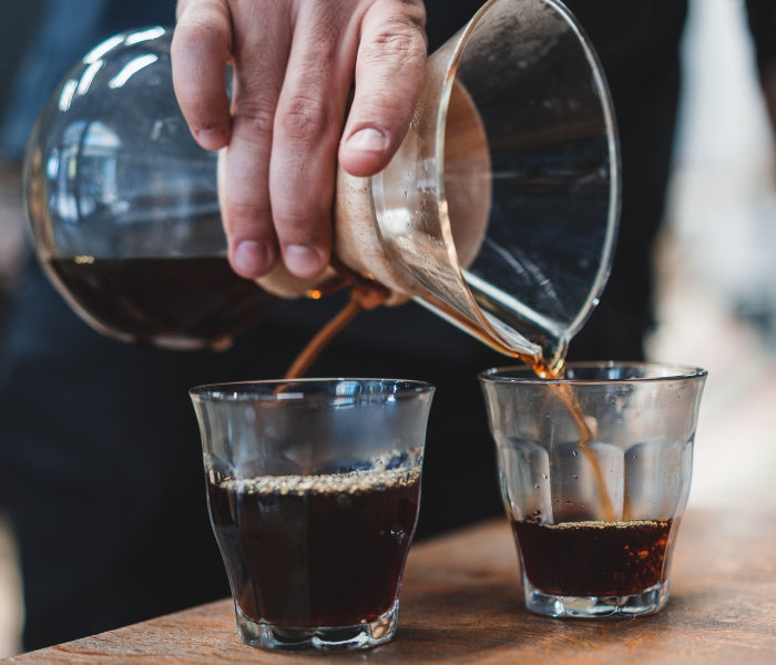 Two coffee glasses showcasing single origin vs blends debate made using Chemex