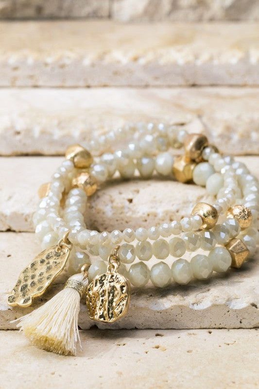 Shimmering glass beaded bracelet set with charms