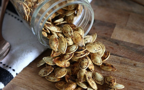 Spilled jar of pumpkin seeds