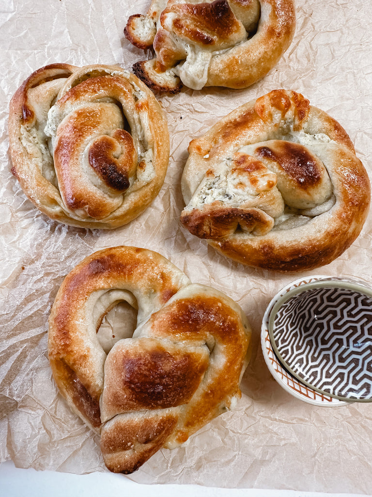 baked stuffed pretzels on crinkled parchment paper.