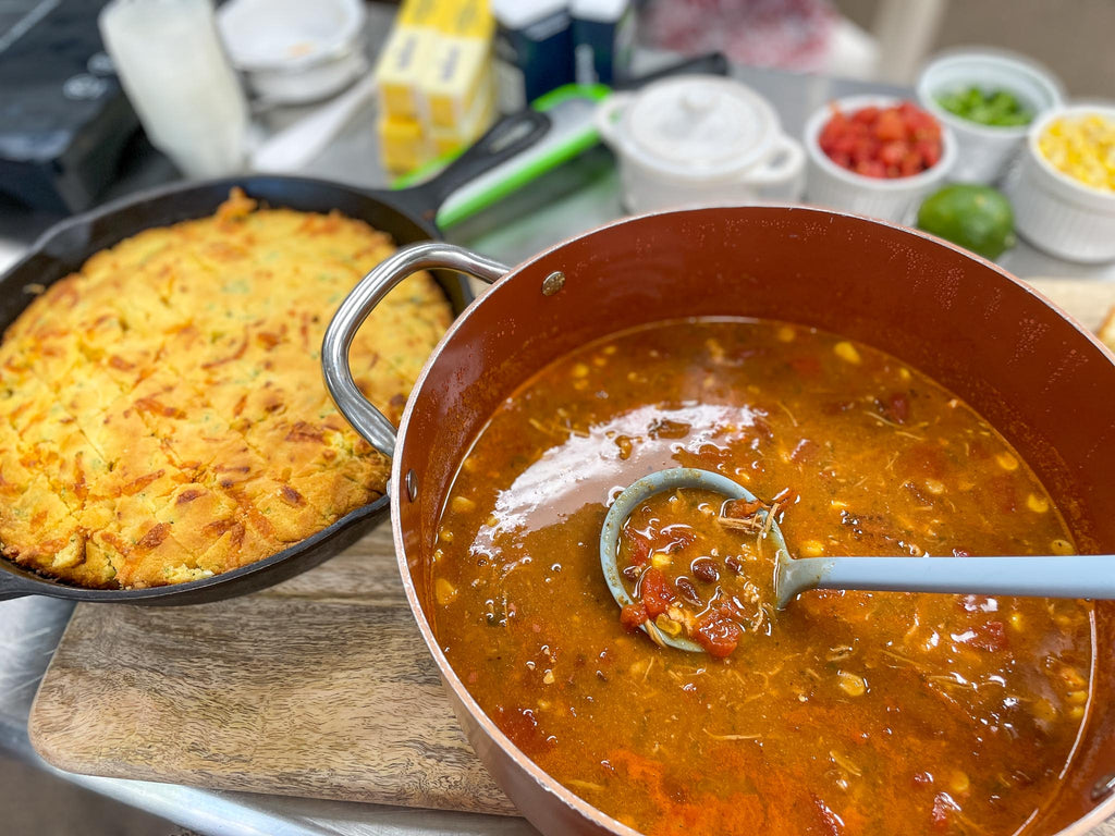 a stock pot of chicken tortilla soup and a cast iron skillet of jalapeno cornbread