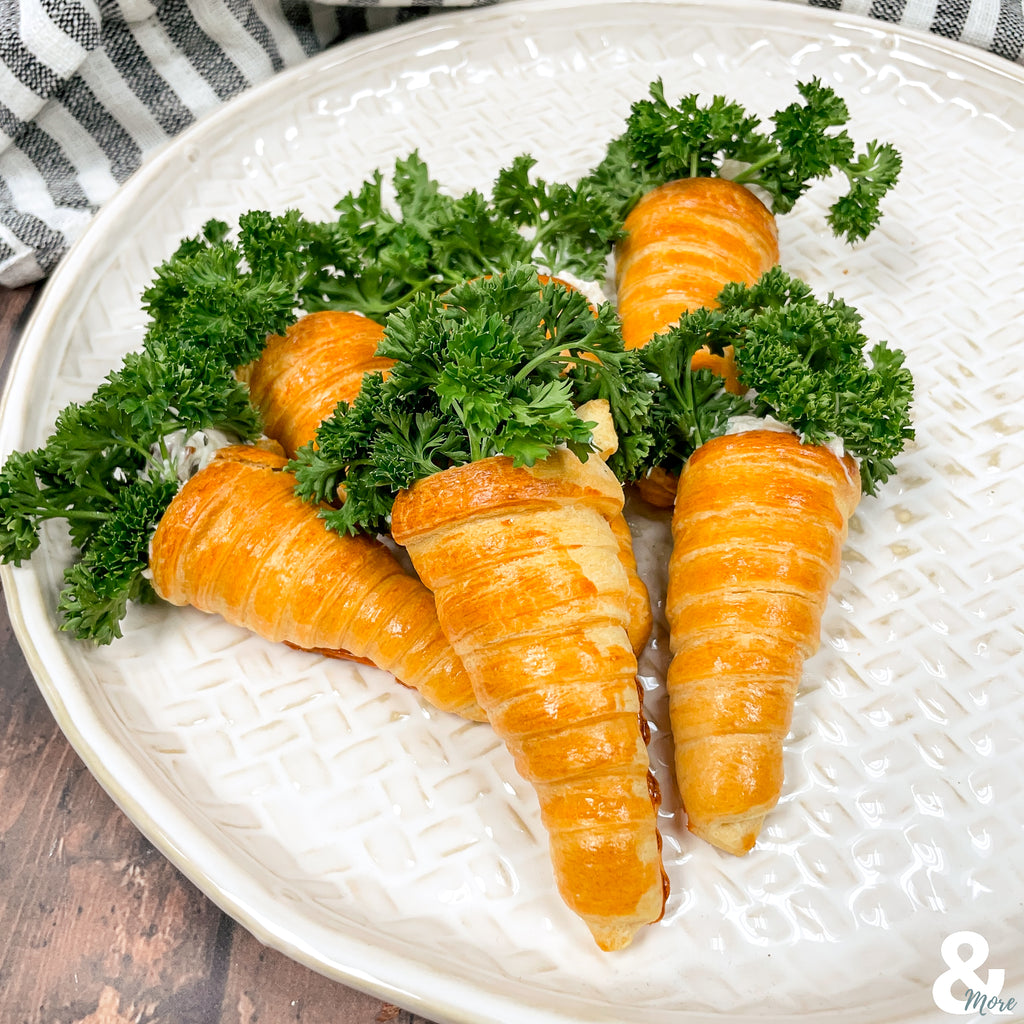 plate of croissant carrot rolls with parsley green tops 