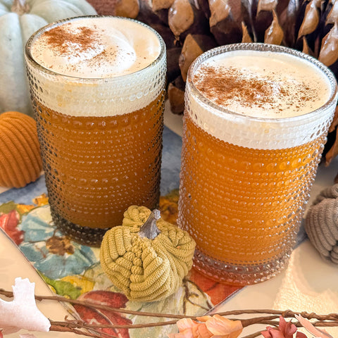 close up of two glasses of pumpkin pie cider fizz topped with toasted marshmallow whipped cream