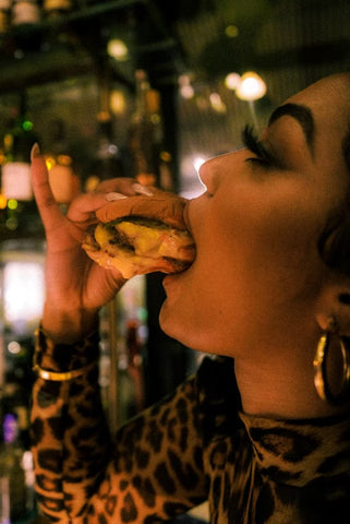 Young woman eating a cheeseburger